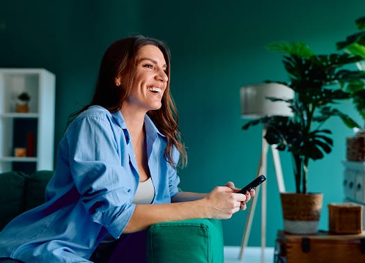 Woman smiling with cell phone in hand